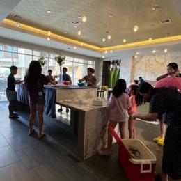 a group of people standing around a kitchen island