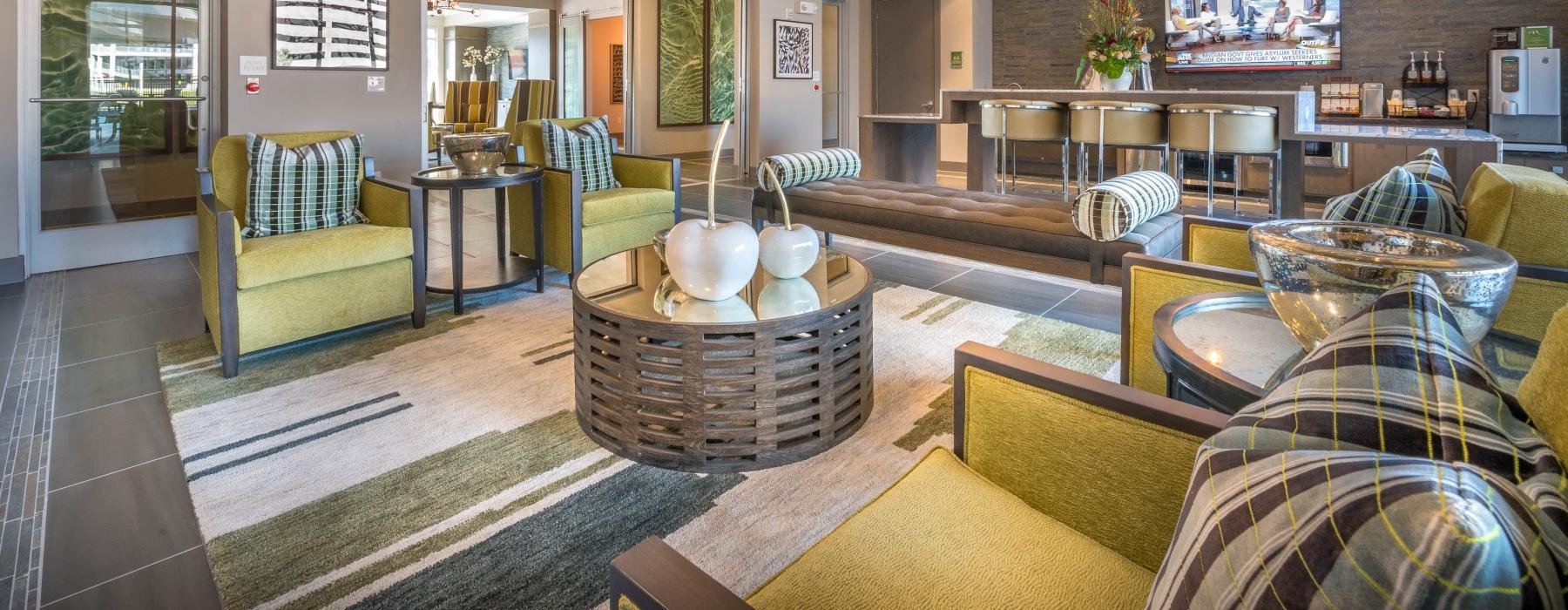 a lounge room with a couch and chairs