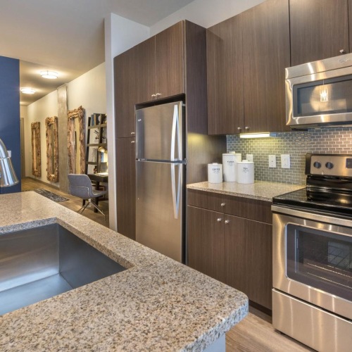 a kitchen with stainless steel appliances and brown cabinets