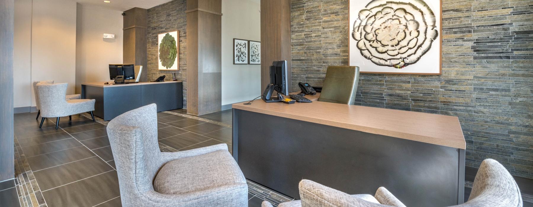 a lobby with a desk and chairs