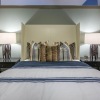 a bedroom with a bed and side tables with lamps