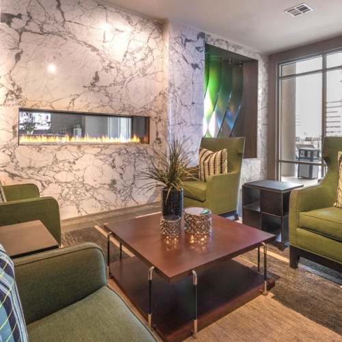 a lounge room with green couches