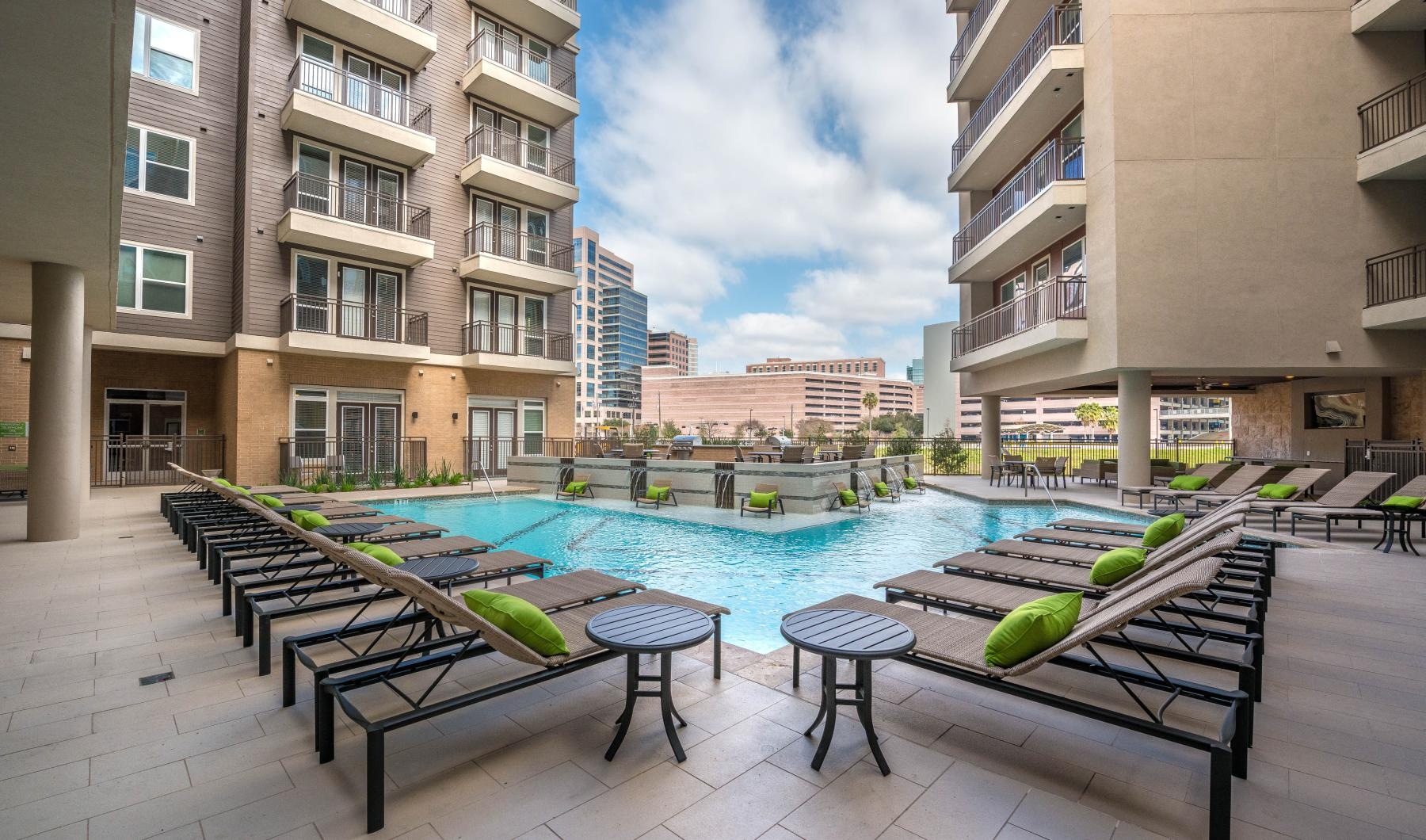 a pool in a courtyard between buildings