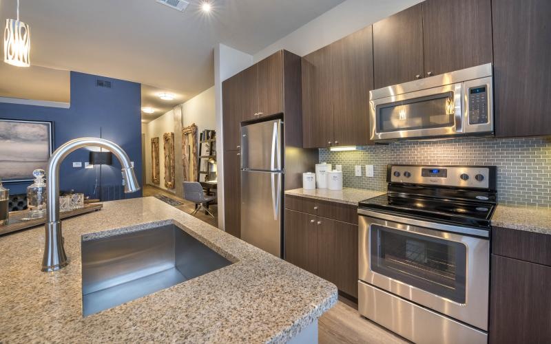 a kitchen with stainless steel appliances and brown cabinets