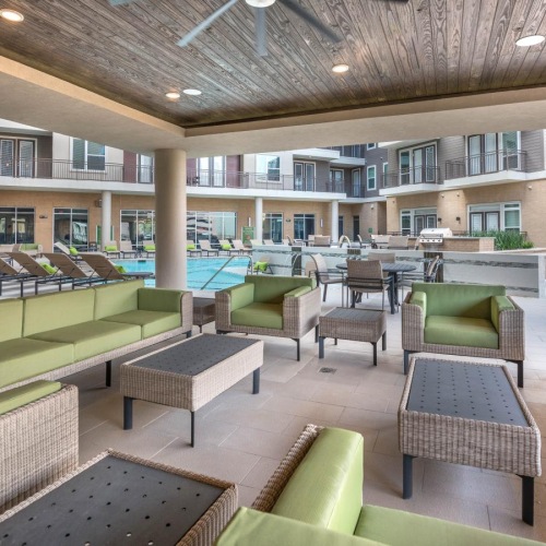 a large deck with a pool and chairs